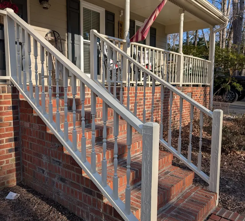 Freshly painted porch railing and brick steps in Fuquay-Varina, NC